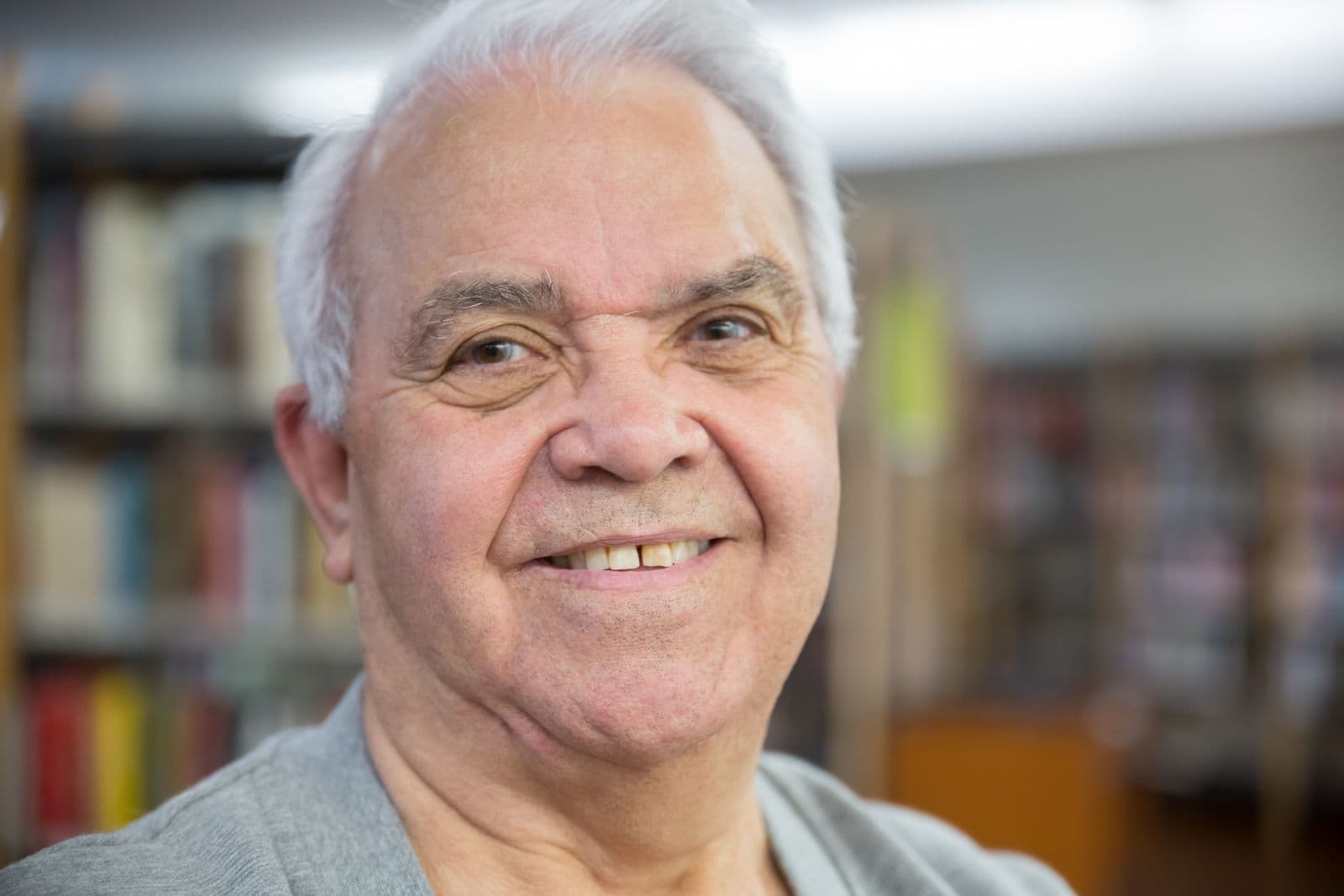 Older man smiling, indoor portrait