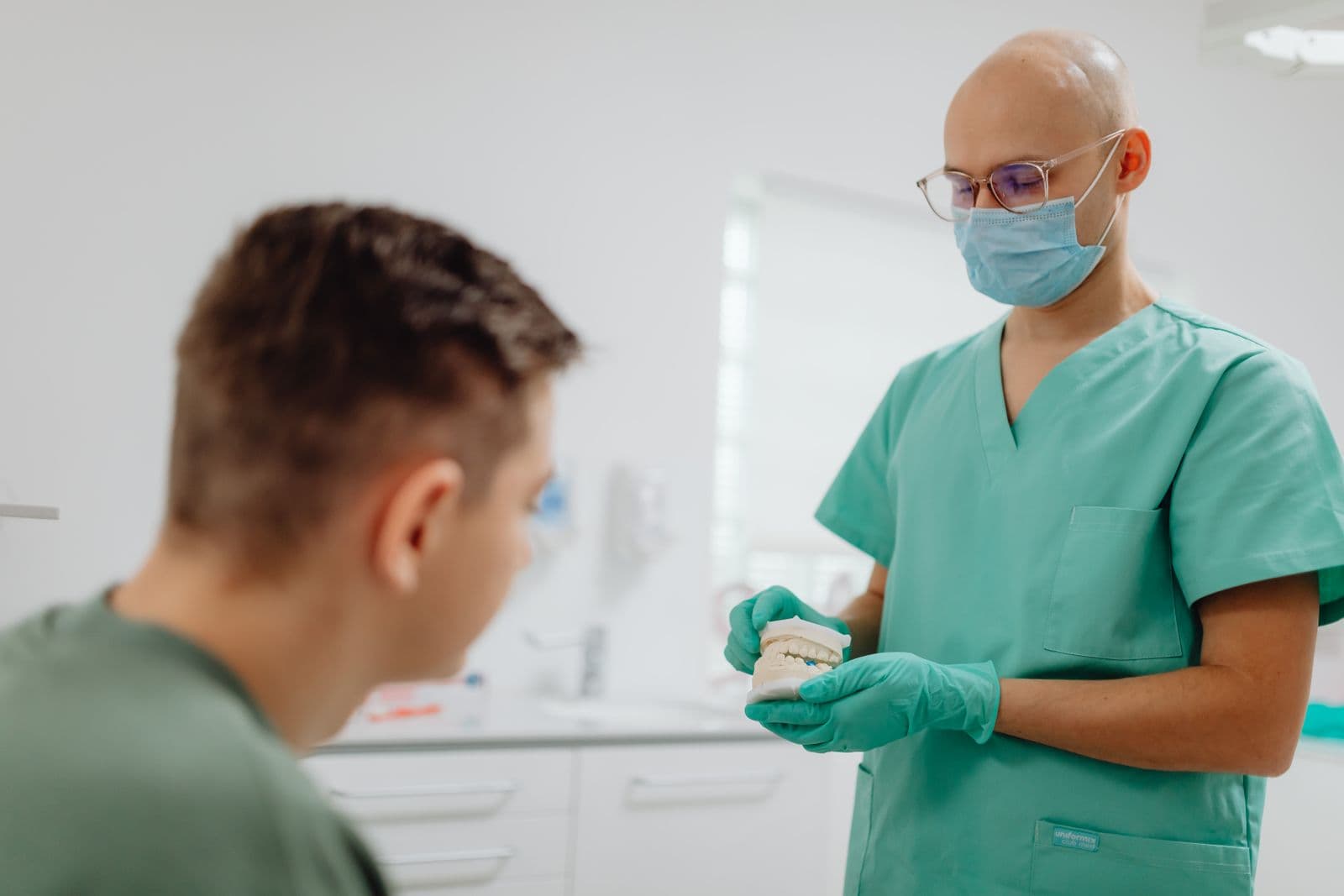 Surgeon in scrubs talking with a patient